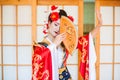 Cosplay. beautiful, modest geisha in a red kimono Royalty Free Stock Photo