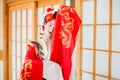 Cosplay. beautiful, modest geisha in a red kimono Royalty Free Stock Photo