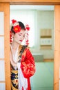 Cosplay. beautiful, modest geisha in a red kimono Royalty Free Stock Photo