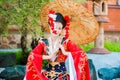 Cosplay. beautiful, modest geisha in a red kimono Royalty Free Stock Photo