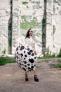 Cosplay on Cruella de Vil with a Dalmatian