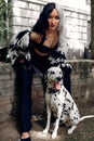 Cosplay on Cruella de Vil with a Dalmatian