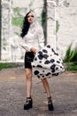 Cosplay on Cruella de Vil with a Dalmatian