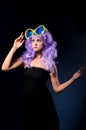 Cosplay girl in purple wig with big sunglasses Royalty Free Stock Photo