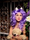 Cosplay girl in purple wig with soft toy