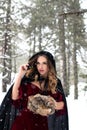Cosplay model portrait in a winter forest. Snow white, red riding hood, medieval model cosplay Royalty Free Stock Photo