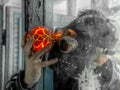 Cosplay of a stalker in a plague doctor mask holding a mysterious artifact and looking at it through glass. art photo