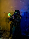 Cosplay of a stalker in a plague doctor mask holding a mysterious luminous artifact. art photo Royalty Free Stock Photo