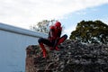 Cosplay to the Lucca Comics disguised as Spiderman posing over a wall