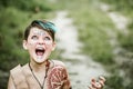 cosplay of Ukrainian Kozak. Cute Caucasian boy holding mace with emblem of Ukraine pretending to be fearless warrior