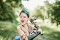 cosplay of Ukrainian Kozak. Cute Caucasian boy holding mace with emblem of Ukraine pretending to be fearless warrior