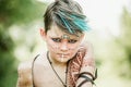 cosplay of Ukrainian Kozak. Cute Caucasian boy holding mace with emblem of Ukraine pretending to be fearless warrior