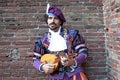 Cosplayer dressed as Minstrel or Jester playing the Oud, medieval singer at the Lucca Comics and Games 2022 cosplay event. Royalty Free Stock Photo