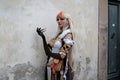 Cosplayer girl dressed as Ningguang, character from the video game Genshin Impact. Lucca Comics and Games 2023.
