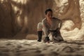 Cosplayer girl portrays character Rey Skywalker from the Star Wars universe among sandy canyon in desert