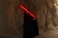 Cosplayer portrays character Kylo Ren from the Star Wars universe with lightsaber in his hand among canyon Royalty Free Stock Photo