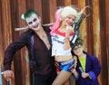 Cosplayers in Harley Quinn costume, in Joker costumes