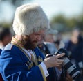 The Cossack photographer shoots at the event. Royalty Free Stock Photo