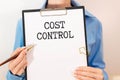 Cost Control Concept . torn paper from a notebook against the background Royalty Free Stock Photo