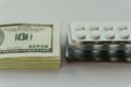 Cost of healthcare, expensive medical treatment concept. Pack of American dollars and pack of drugs Royalty Free Stock Photo