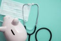 Cost of healthcare. Piggy bank money box with a medical doctors stethoscope Royalty Free Stock Photo