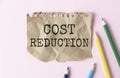 Cost Reductions words on copybook page.