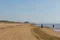 People taking morning walk exercise on beautiful natural beach between Torre La mata and Guardamar de Segura Costa Blanca Spain