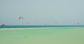 Costa Calma, Fuerteventura. Free kiters on the ocean waves. Kitesurfing in the shallow blue transparent water. Paradise