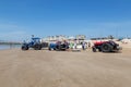 Costa da Caparica, Portugal - September 10, 2020: An artel of fishermen trawls fish from the tourist beach using a tractors.