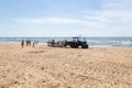 Costa da Caparica, Portugal - September 10, 2020: An artel of fishermen trawls fish from the tourist beach using a tractors.