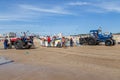 Costa da Caparica, Portugal - September 10, 2020: An artel of fishermen trawls fish from the tourist beach using a tractors.