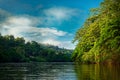 Costa Rica landscape from Boca Tapada, Rio San Carlos. Riverside with meadows and cows, tropical cloudy forest in the background.