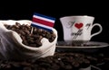 Costa Rican flag in a bag with coffee beans isolated on black Royalty Free Stock Photo