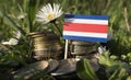 Costa Rican flag with stack of money coins with grass Royalty Free Stock Photo