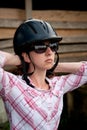 Costa Rican tourist putting on equestrian helmet