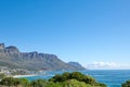 Costal city surrounded by nature with an iconic landmark in the background in urban Cape Town. Scenic view of mountain