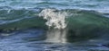 Costal sea/ocean crashing wave with foam on its top