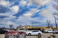 Costco retail superstore building sign and parked cars distant view dark look edited