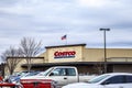 Costco retail superstore building sign and parked cars distant view of the store