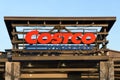 Costco Wholesale sign suspended on metal frame at warehouse