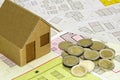 Costs about buildinh activity - Housing concept with cardboard house, euro coins and imaginary cadastral map