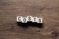 Costs - word concept on building blocks, text