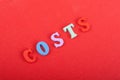 costs word on red background composed from colorful abc alphabet block wooden letters, copy space for ad text. Learning english