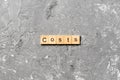 Costs word written on wood block. costs text on cement table for your desing, concept