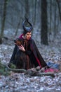 Costume Drama. Charming and Mysterious Maleficent Female with Highbred Dog on Leash. Posing Together in Early Spring Forest