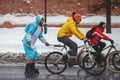 Costumed cyclist rides along the walls of the Kremlin in the winter.