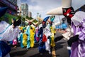 Costumed people dance and play in the street during the pre-carn