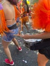 Costumed woman playing repique on the drums of a street block at the carnival in Belo Horizonte, Brazil