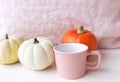 Cosy autumn morning breakfast in bed still life scene. A steaming cup of hot coffee and pumpkins. Fall, Thanksgiving