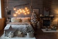 Cosy bedroom with eco decor. Wood and nature concept in interior of room. Scandinavian interior with christmas tree, real photo. H Royalty Free Stock Photo